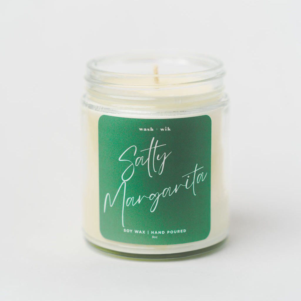 Candle with a green label on a white background