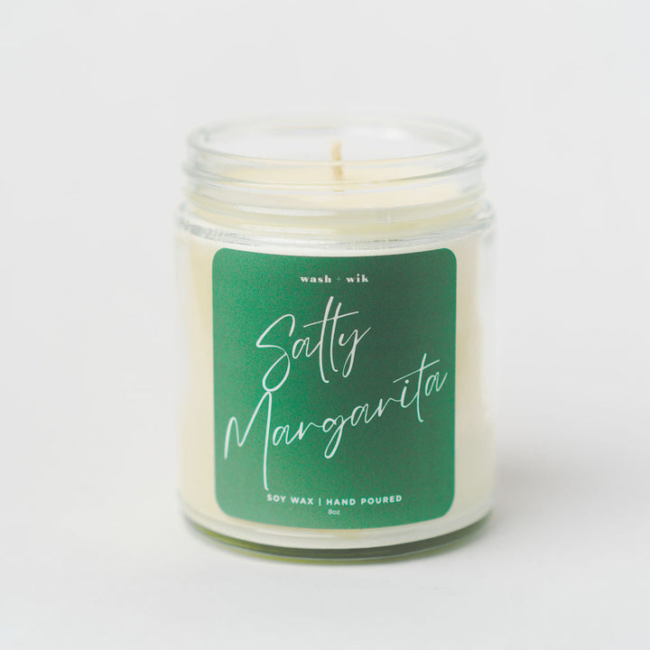 Candle with a green label on a white background