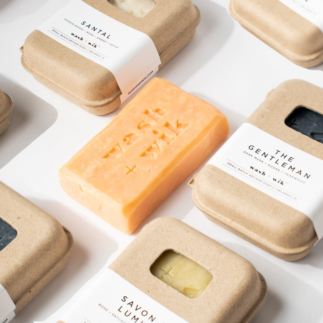 Various soap bars in different packaging on a white background