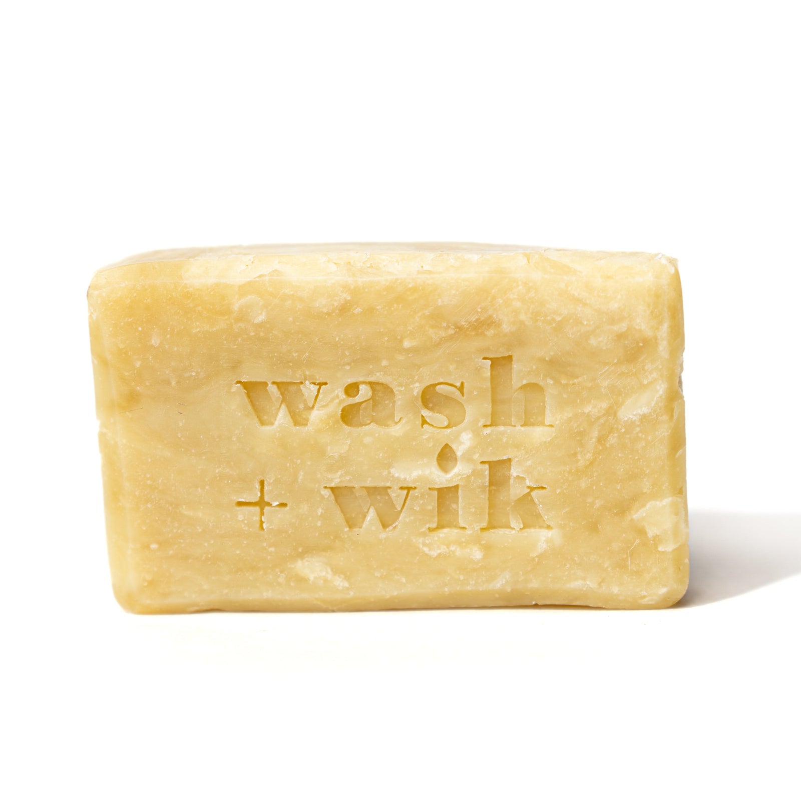 Bar of soap with 'wash + wik' branding on a white background