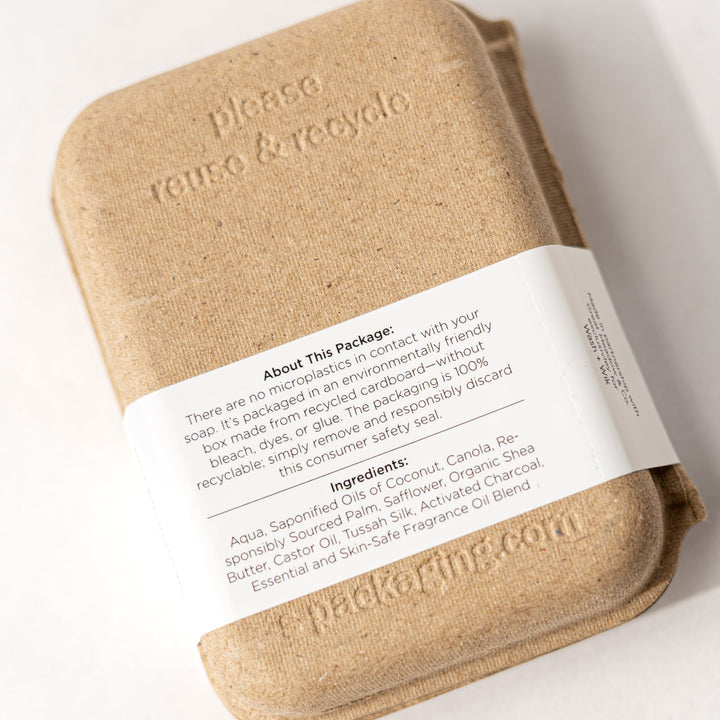 Beige soap bar with a label on a white background