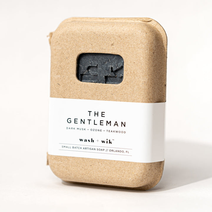 Bar of soap in a kraft paper packaging with a label on a white background