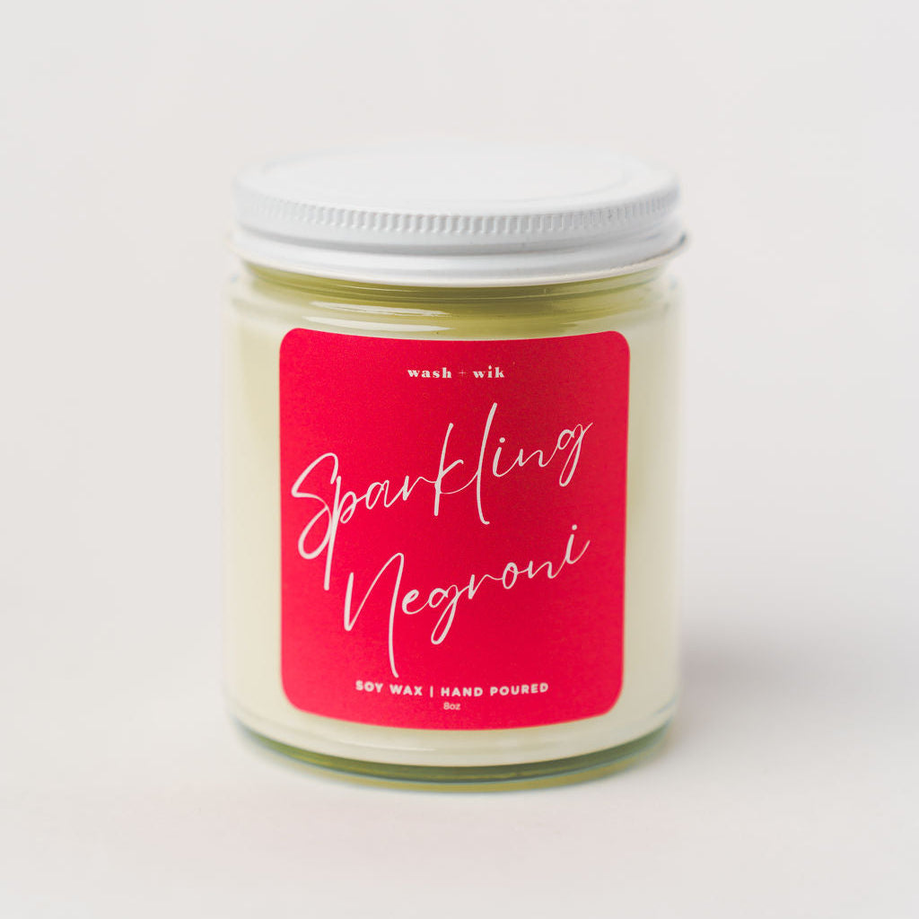 Candle jar with a pink label on a white background