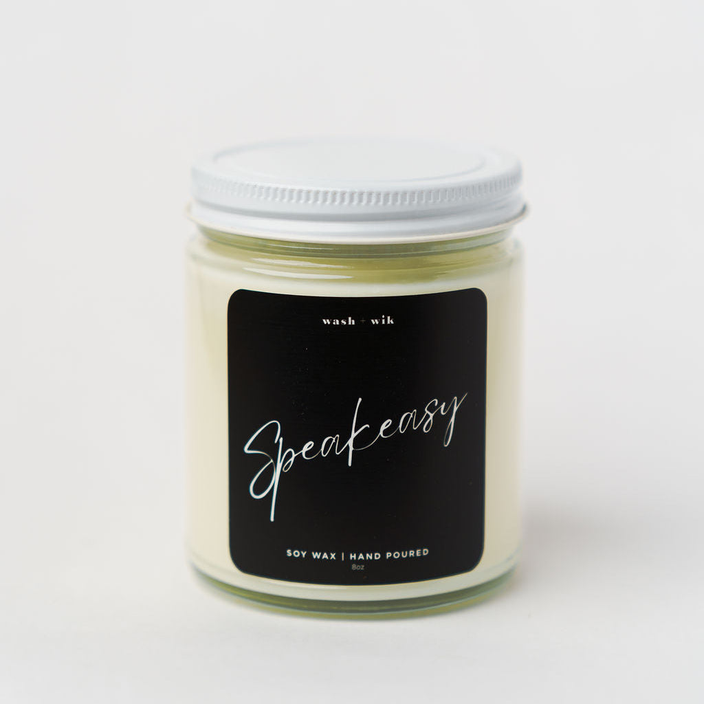 Candle jar with a black label on a white background