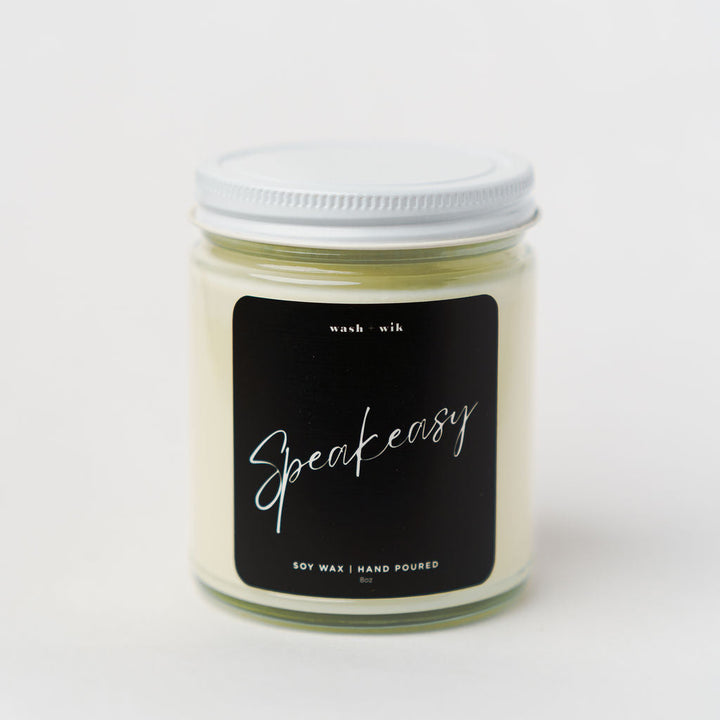 Candle jar with a black label on a white background