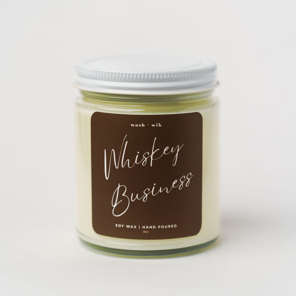 Candle jar labeled 'Whiskey Business' on a white background