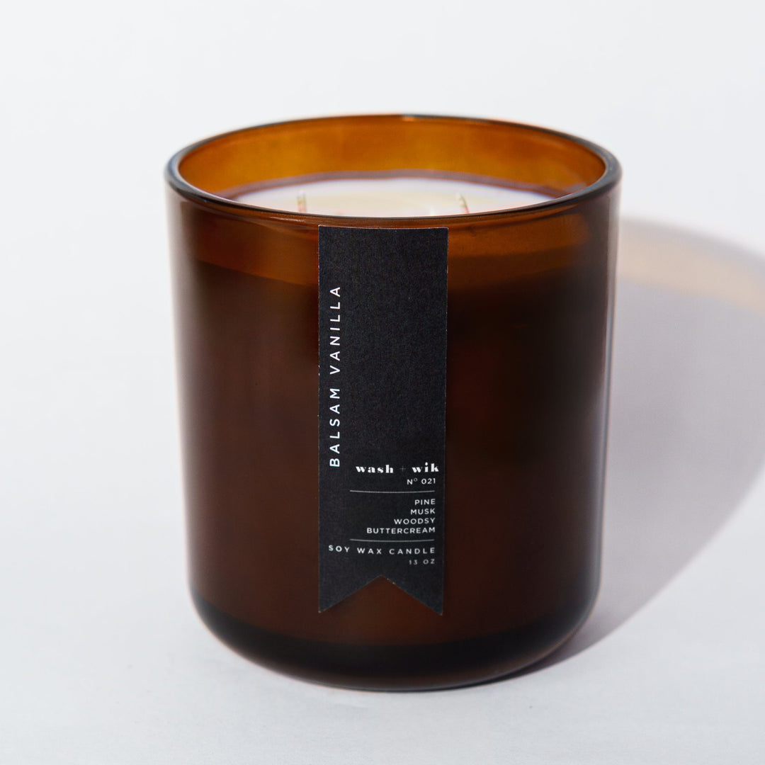 Amber candle with two wicks with a white background