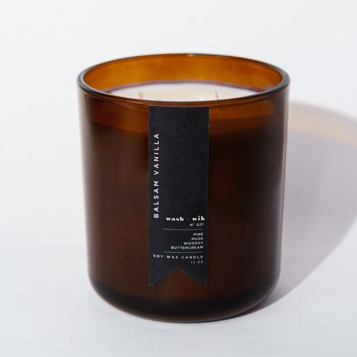 Amber candle with two wicks with a white background