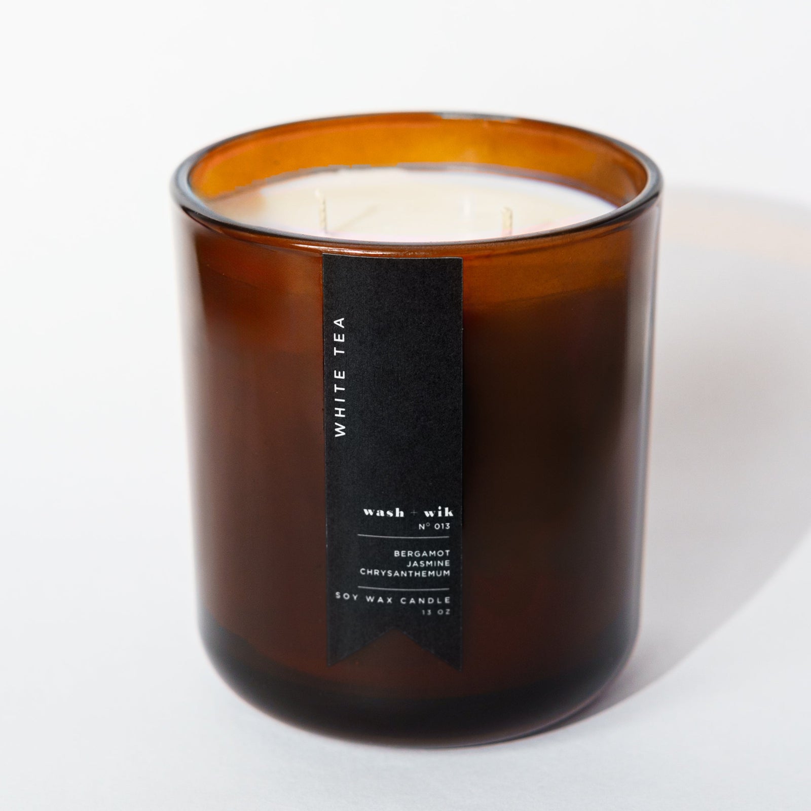 Amber candle with two wicks with a white background