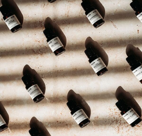 A bunch of bottles are lined up on the floor