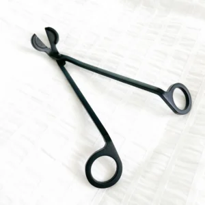 A pair of black scissors sitting on top of a table.