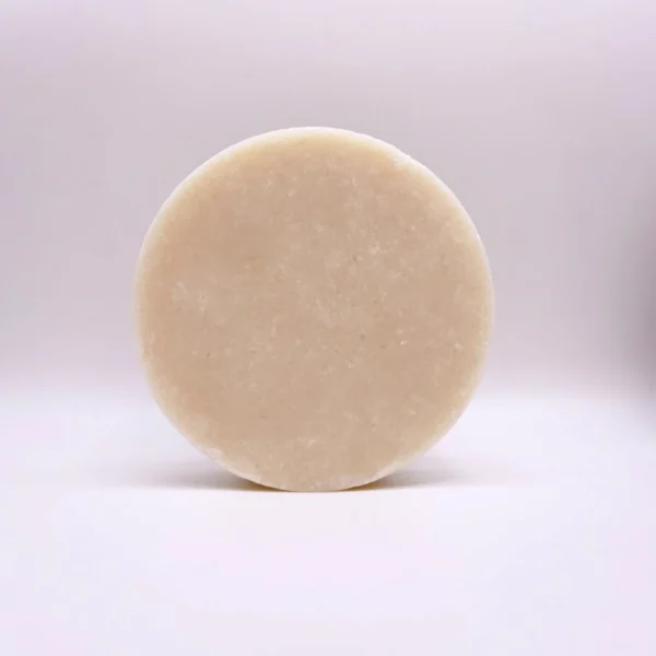 A white round soap sitting on top of a table.