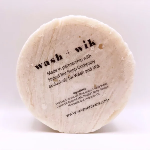 A round white soap with the words wash and wik written on it.