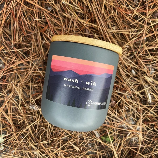 A candle sitting on top of some grass