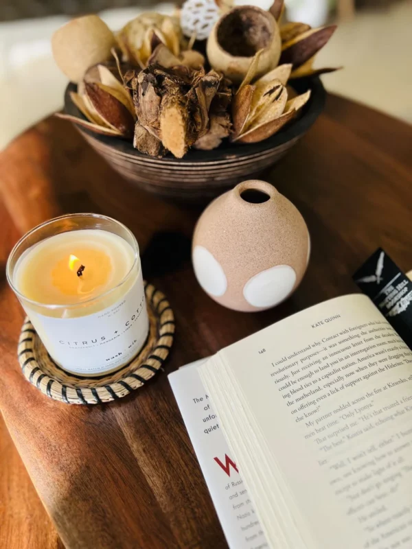 A candle and book on the table