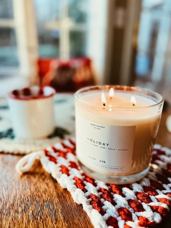 A candle sitting on top of a table next to some other candles.