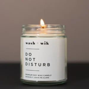 A candle that has the words " do not disturb " on it.