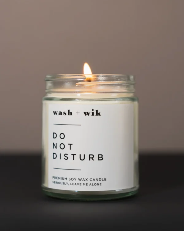 A candle that has the words " do not disturb " on it.