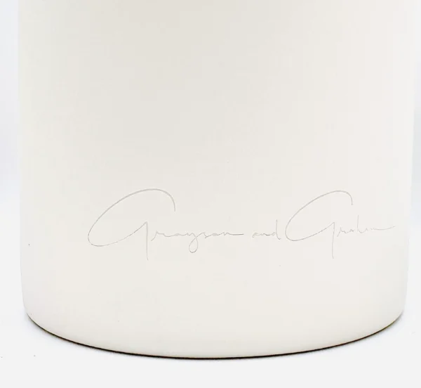 A close up of the signature on a white candle