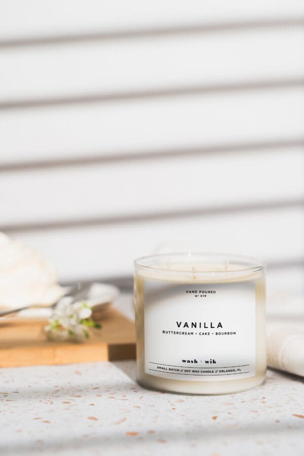 A candle sitting on top of a wooden table.