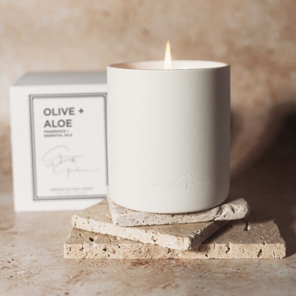 A candle sitting on top of a wooden block.