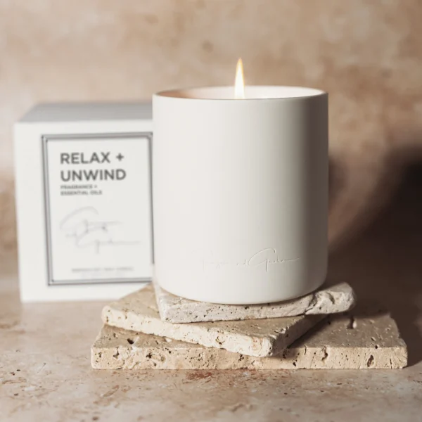 A candle sitting on top of some coasters.